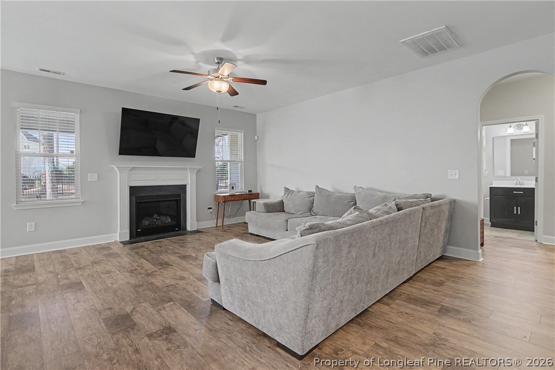 47 Pinnacle Drive Spring Lake, NC 28390 - Photo 9 of 50 a living room with furniture a flat screen tv and a fireplace