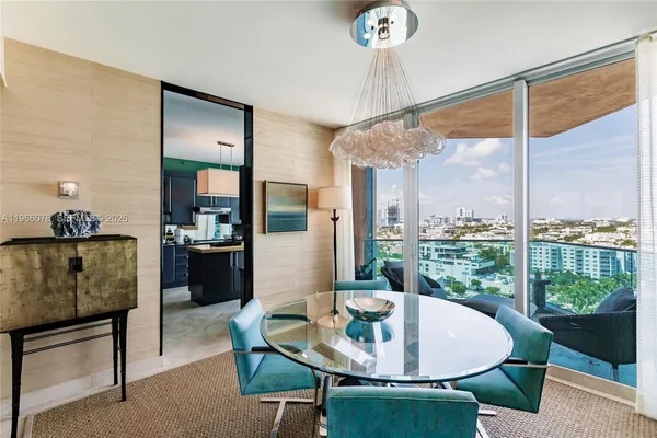 a living room with furniture and a floor to ceiling window