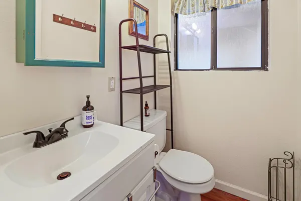 a bathroom with a sink and mirror with toilet