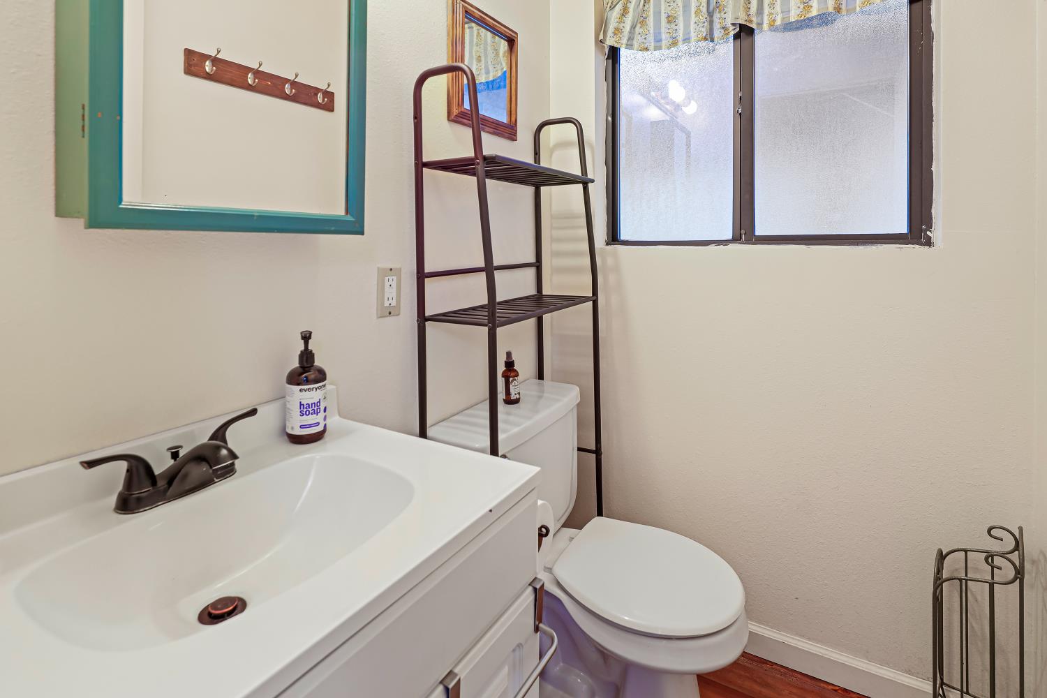9174 State Rte 26 Mokelumne Hill, CA 95245 - Photo 14 of 52 a bathroom with a sink and mirror with toilet