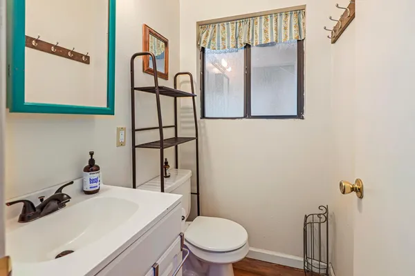 a bathroom with a sink toilet and mirror