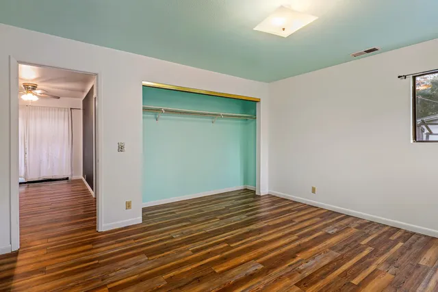 a view of a room with wooden floor and window