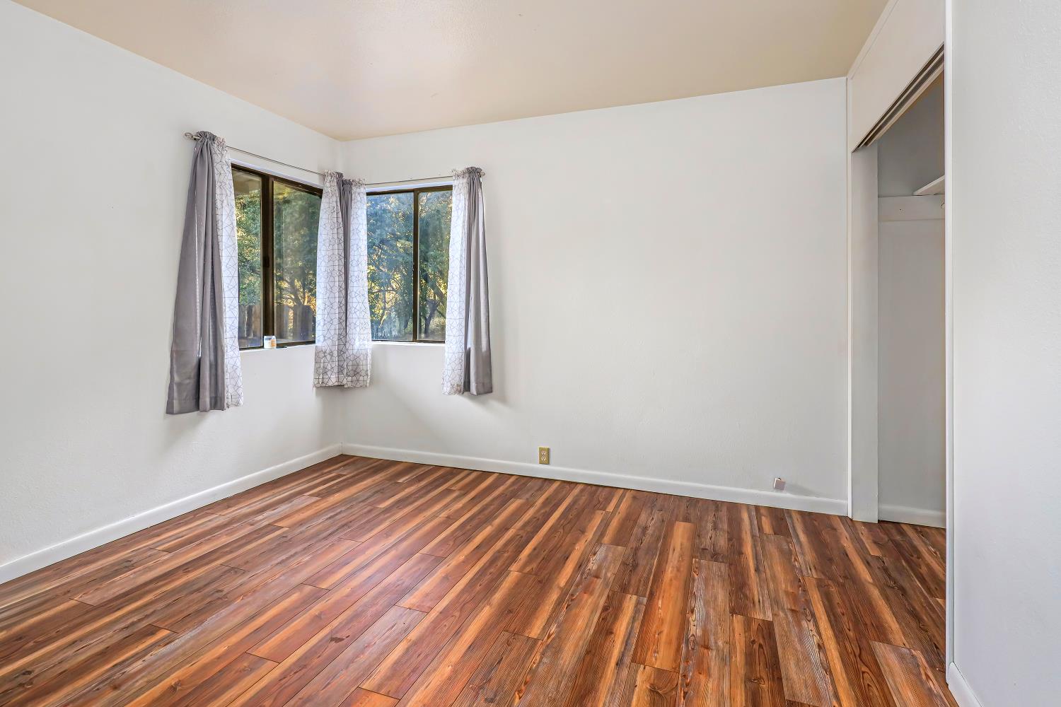 9174 State Rte 26 Mokelumne Hill, CA 95245 - Photo 18 of 52 a view of an empty room with wooden floor and a window
