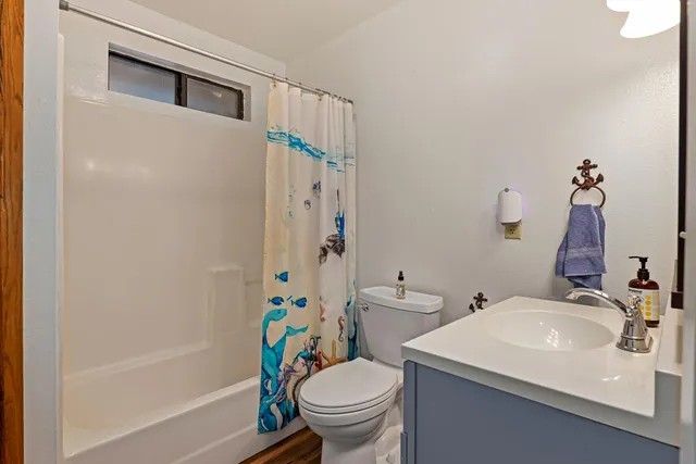 a view of house with a yard and potted plants
