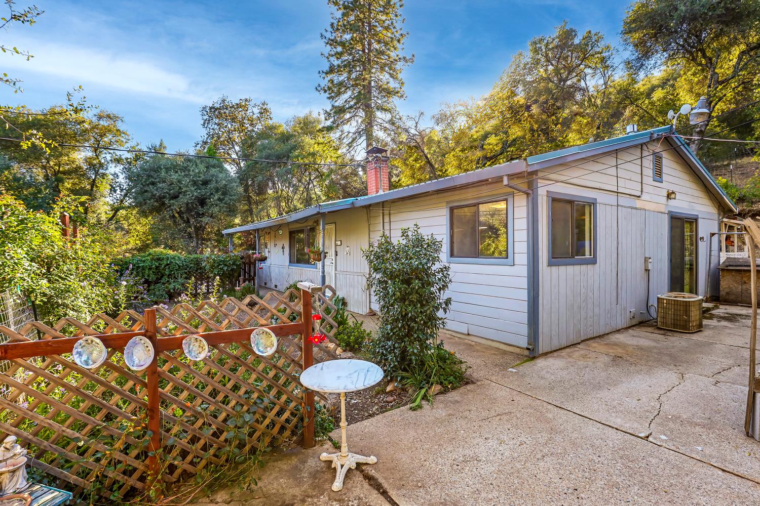 9174 State Rte 26 Mokelumne Hill, CA 95245 - Photo 24 of 52 a front view of house with yard and trees around