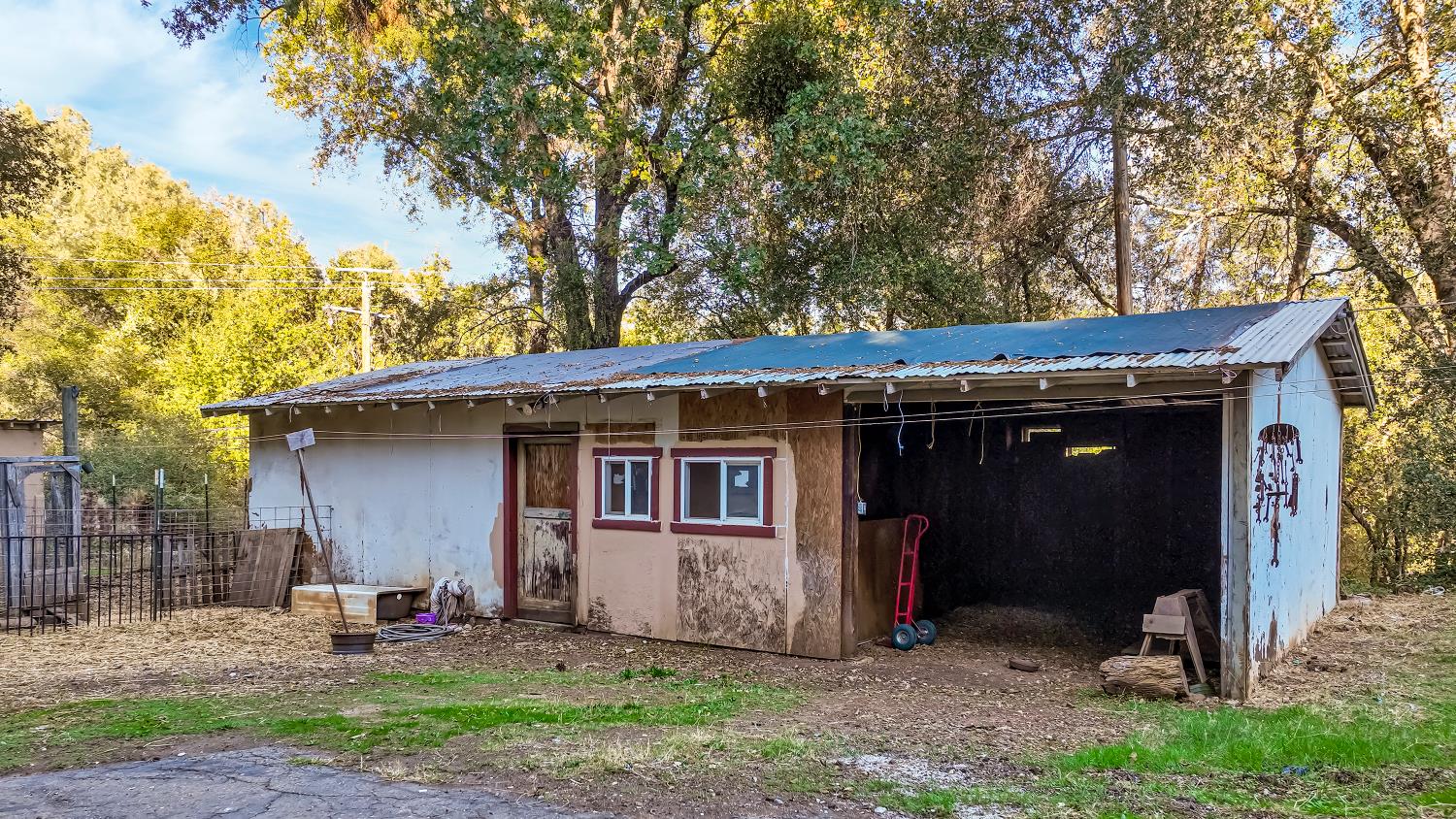 9174 State Rte 26 Mokelumne Hill, CA 95245 - Photo 35 of 52 a view of a barn in the backyard with large tree and wooden fence