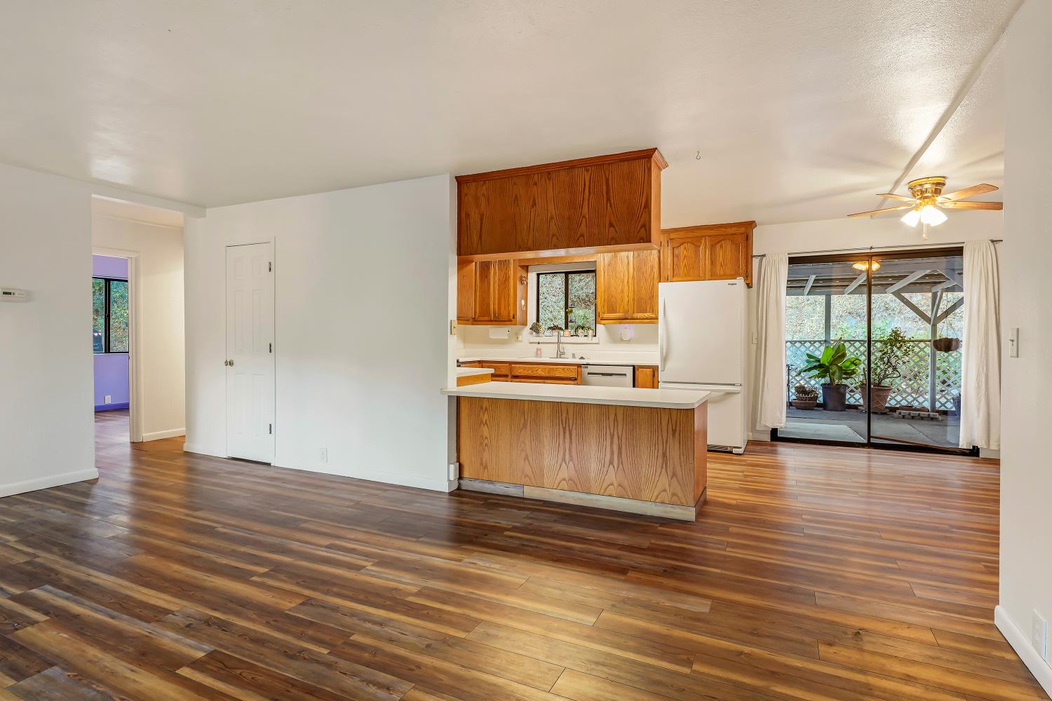 9174 State Rte 26 Mokelumne Hill, CA 95245 - Photo 6 of 52 a view of a kitchen with wooden floor and a window