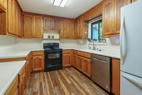 a kitchen with wooden cabinets and stainless steel appliances