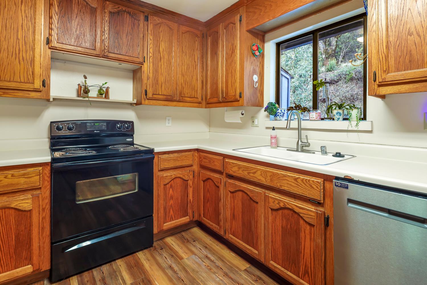 9174 State Rte 26 Mokelumne Hill, CA 95245 - Photo 10 of 52 a kitchen with stainless steel appliances granite countertop a sink a stove a microwave and cabinets