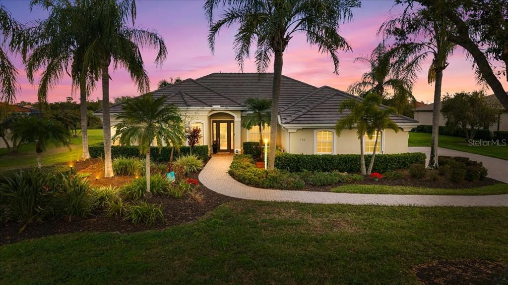 709 Country Meadows Way Bradenton, FL 34212 - Photo 1 of 97 a front view of a house with a garden
