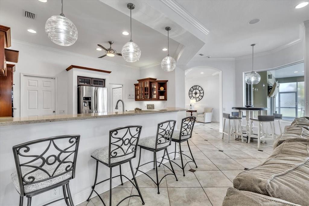 709 Country Meadows Way Bradenton, FL 34212 - Photo 18 of 97 a view of a dining room with furniture and chandelier