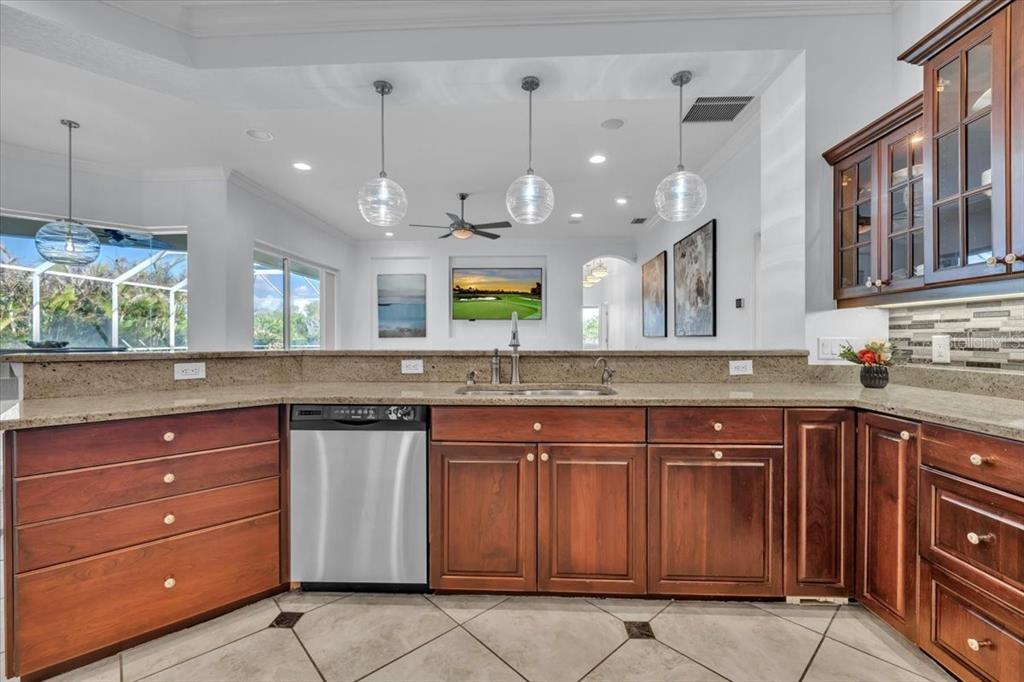 709 Country Meadows Way Bradenton, FL 34212 - Photo 28 of 97 a kitchen with a sink and a wooden cabinets