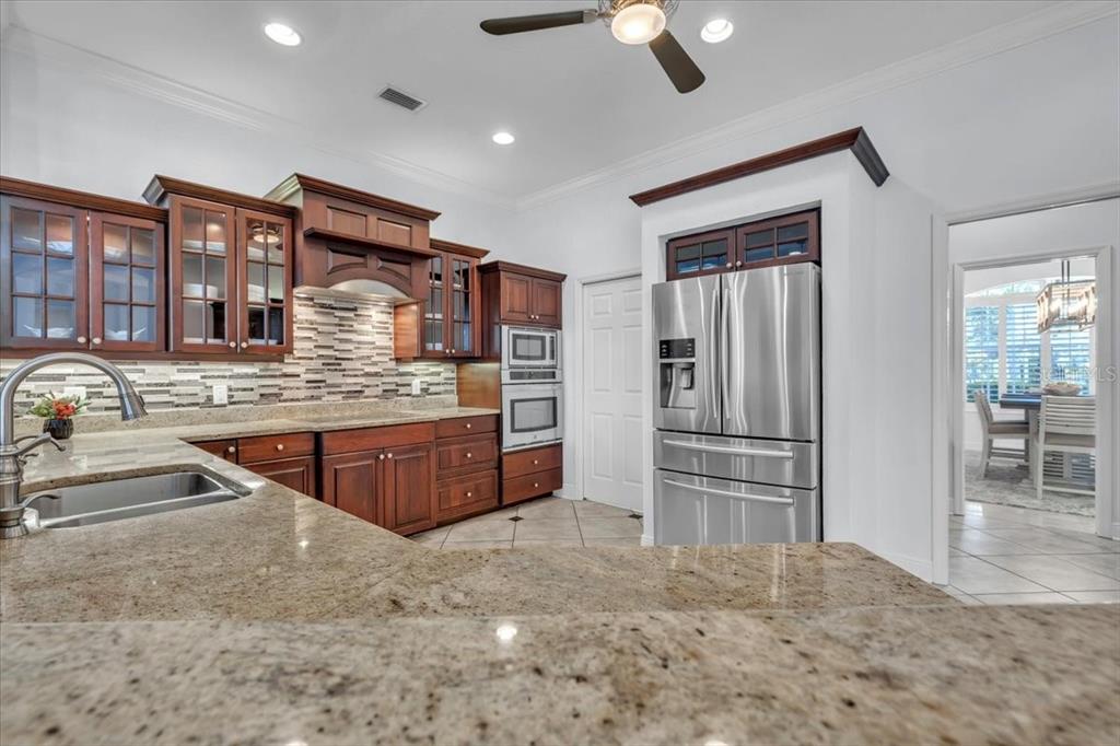 709 Country Meadows Way Bradenton, FL 34212 - Photo 29 of 97 a kitchen with stainless steel appliances granite countertop a refrigerator and a sink