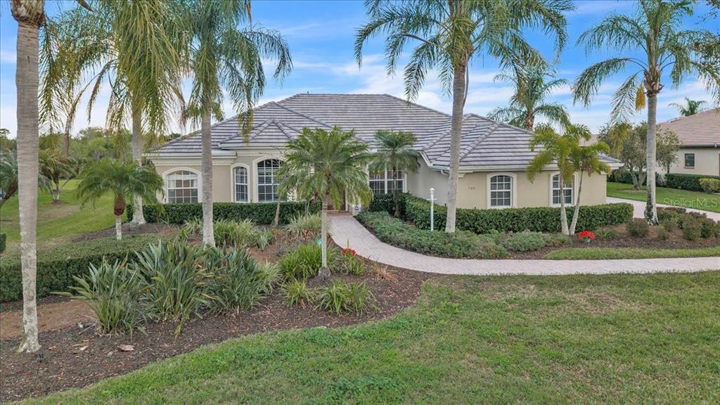 709 Country Meadows Way Bradenton, FL 34212 - Photo 3 of 97 a front view of a house with a garden