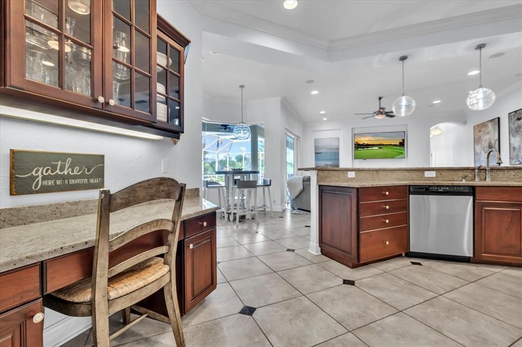 709 Country Meadows Way Bradenton, FL 34212 - Photo 31 of 97 a kitchen with stainless steel appliances granite countertop a stove a sink and a refrigerator