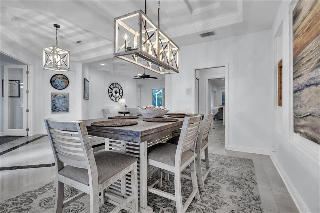 709 Country Meadows Way Bradenton, FL 34212 - Photo 36 of 97 a view of a dining room with furniture and a chandelier