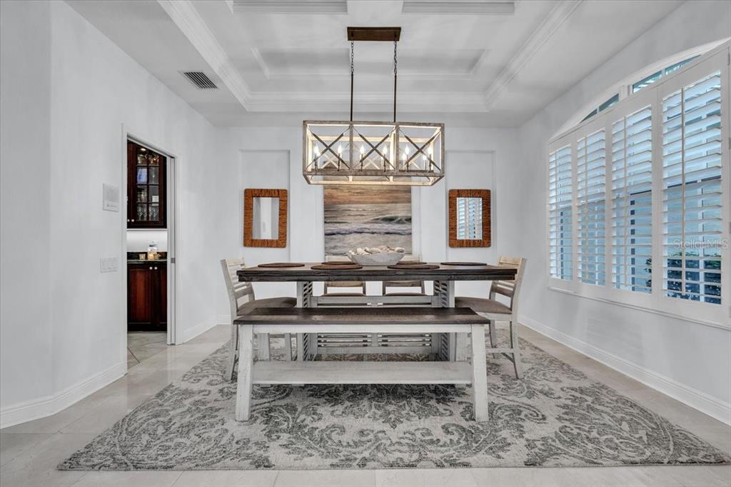 709 Country Meadows Way Bradenton, FL 34212 - Photo 37 of 97 a dining room with table chairs and a chandelier