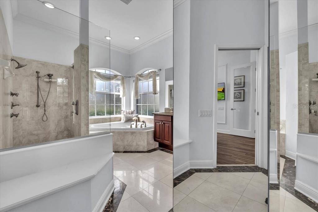 709 Country Meadows Way Bradenton, FL 34212 - Photo 46 of 97 a bathroom with a tub shower and sink