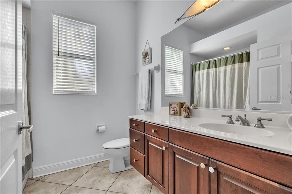 709 Country Meadows Way Bradenton, FL 34212 - Photo 52 of 97 a bathroom with a double vanity sink toilet and a mirror