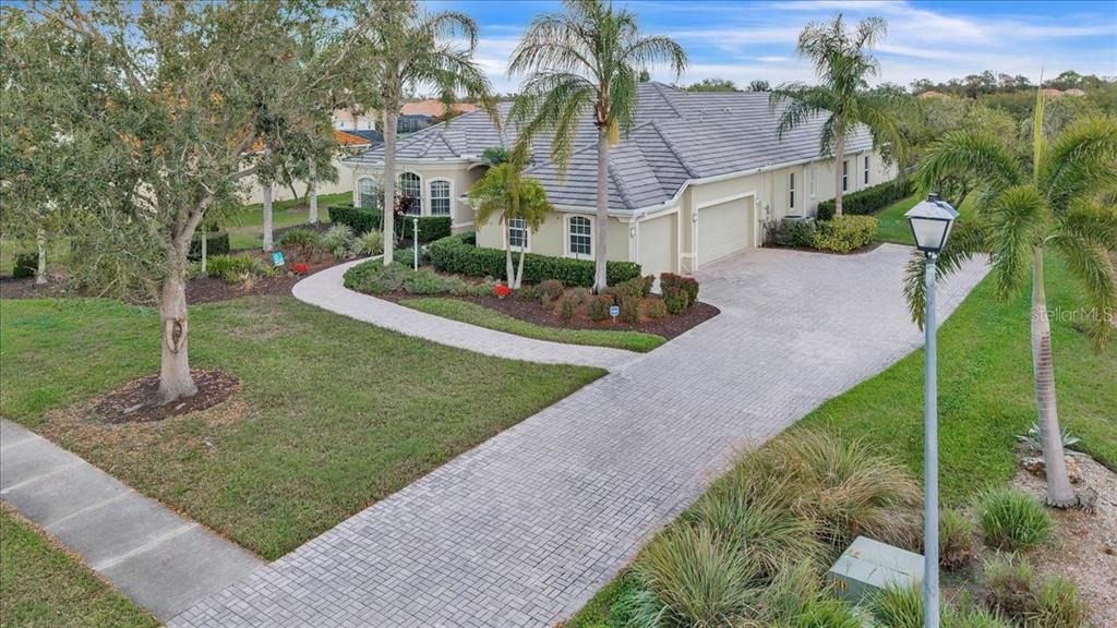 709 Country Meadows Way Bradenton, FL 34212 - Photo 91 of 97 a front view of a house with a yard and potted plants