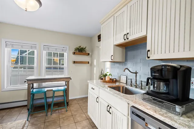a kitchen with a sink cabinets and a window