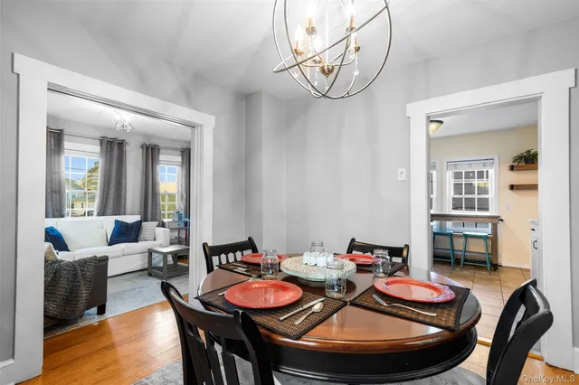 a dining room with furniture a rug and wooden floor