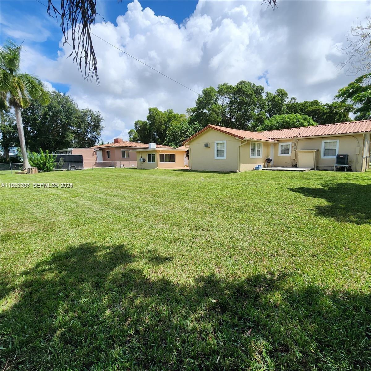 60 Palmetto Drive Miami Springs, FL 33166 - Photo 3 of 12 a front view of a house with a yard and trees