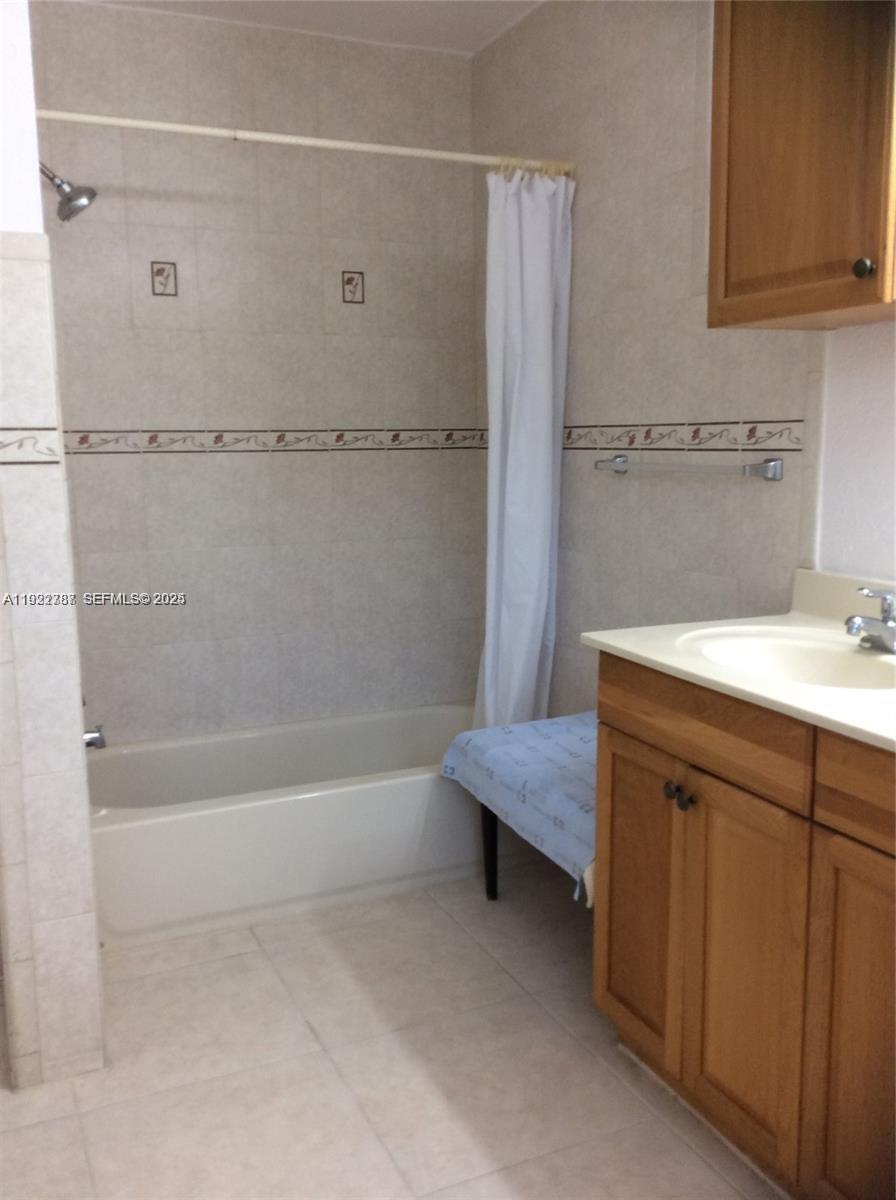 60 Palmetto Drive Miami Springs, FL 33166 - Photo 10 of 12 a spacious bathroom with a tub sink and mirror