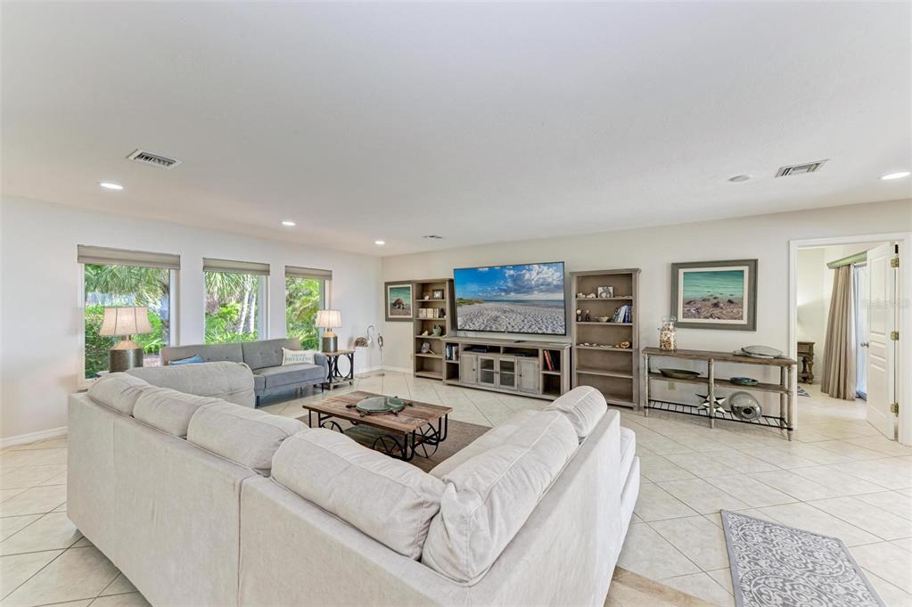 8320 Manasota Key Road Englewood, FL 34223 - Photo 11 of 58 a living room with furniture a large window and gym equipment