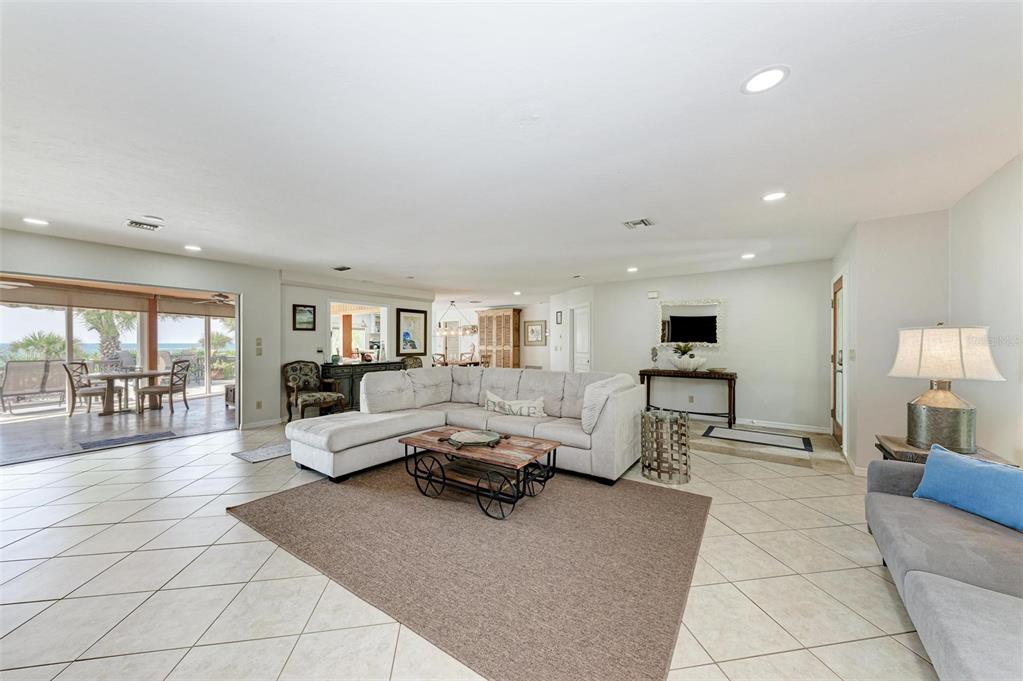 8320 Manasota Key Road Englewood, FL 34223 - Photo 13 of 58 a living room with furniture and a wooden floor