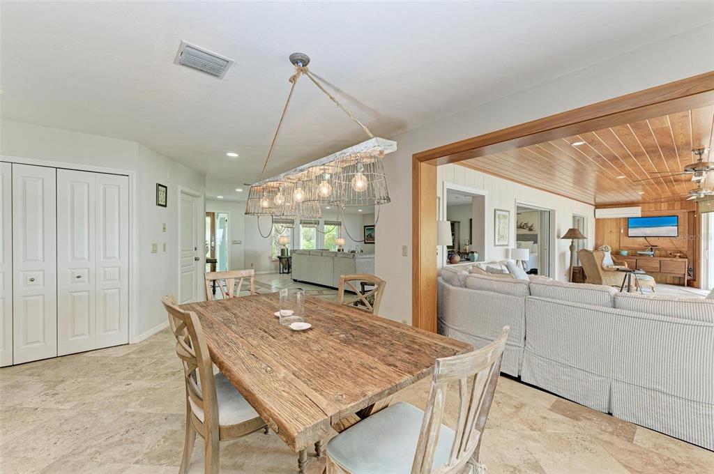 8320 Manasota Key Road Englewood, FL 34223 - Photo 17 of 58 a dining room with a table and chairs