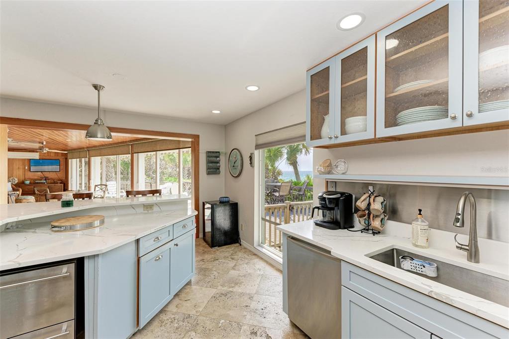 8320 Manasota Key Road Englewood, FL 34223 - Photo 23 of 58 a kitchen with stove a sink and cabinets