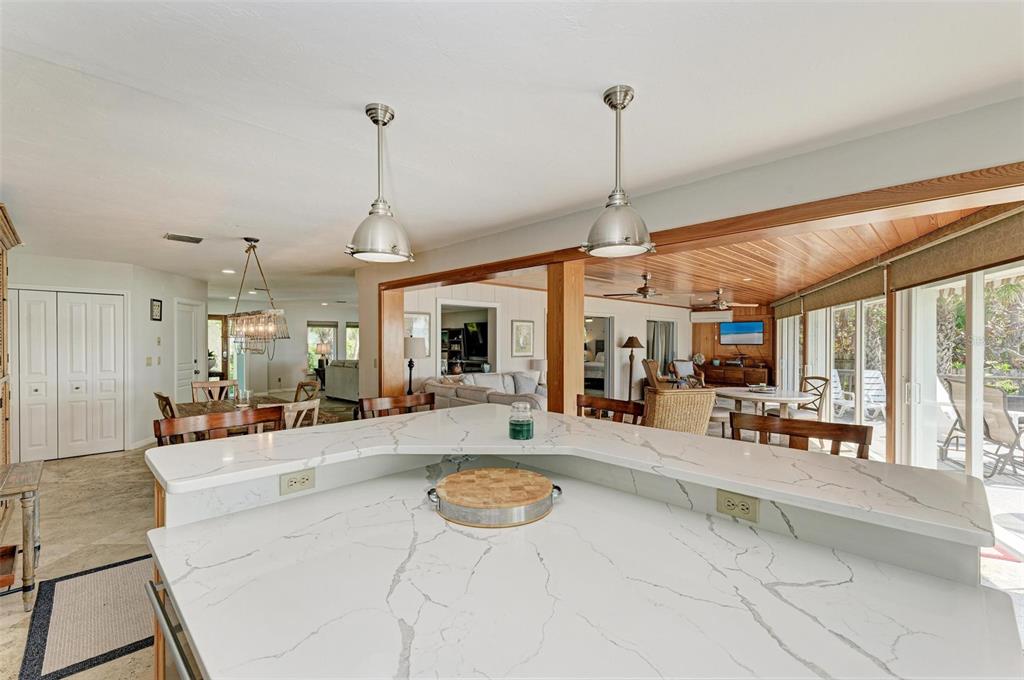 8320 Manasota Key Road Englewood, FL 34223 - Photo 25 of 58 a large living room with stainless steel appliances granite countertop a sink and chandelier