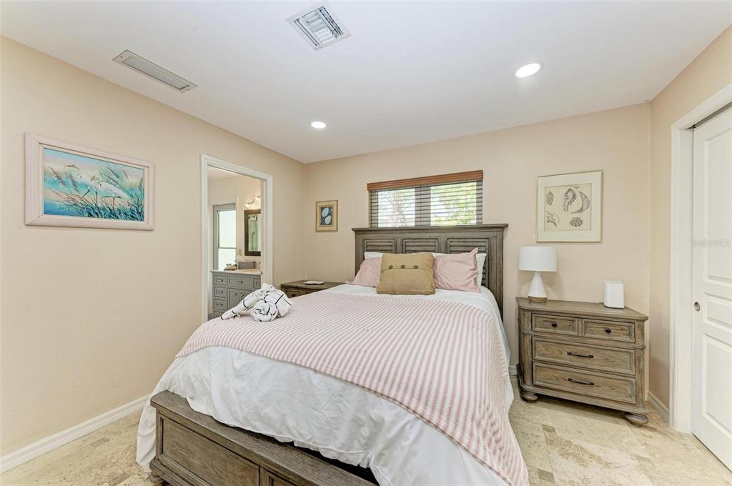 8320 Manasota Key Road Englewood, FL 34223 - Photo 27 of 58 a bedroom with a bed and a painting