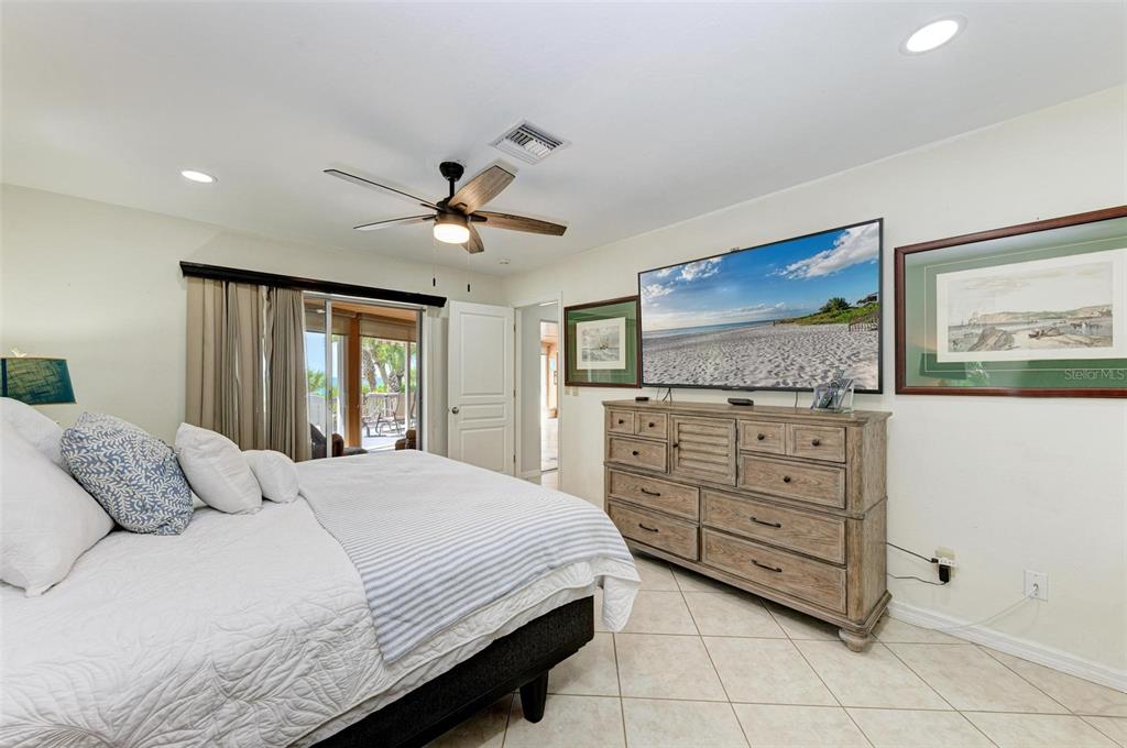 8320 Manasota Key Road Englewood, FL 34223 - Photo 33 of 58 a bedroom with a bed and a flat screen tv