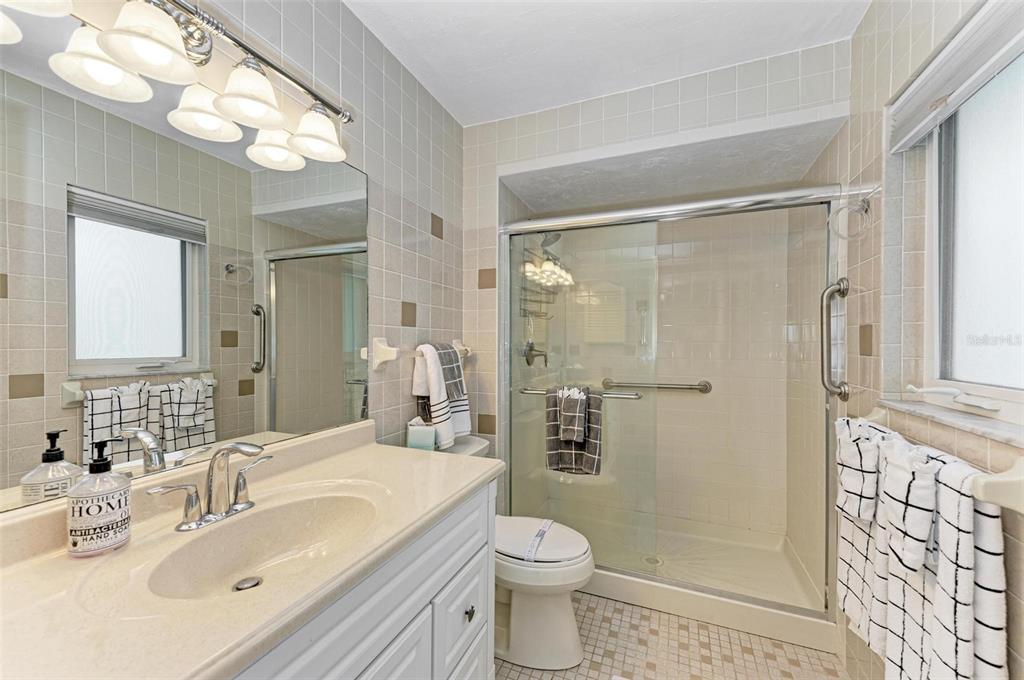 8320 Manasota Key Road Englewood, FL 34223 - Photo 34 of 58 a bathroom with a sink a toilet and shower