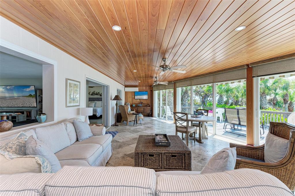 8320 Manasota Key Road Englewood, FL 34223 - Photo 35 of 58 a living room with furniture and large windows