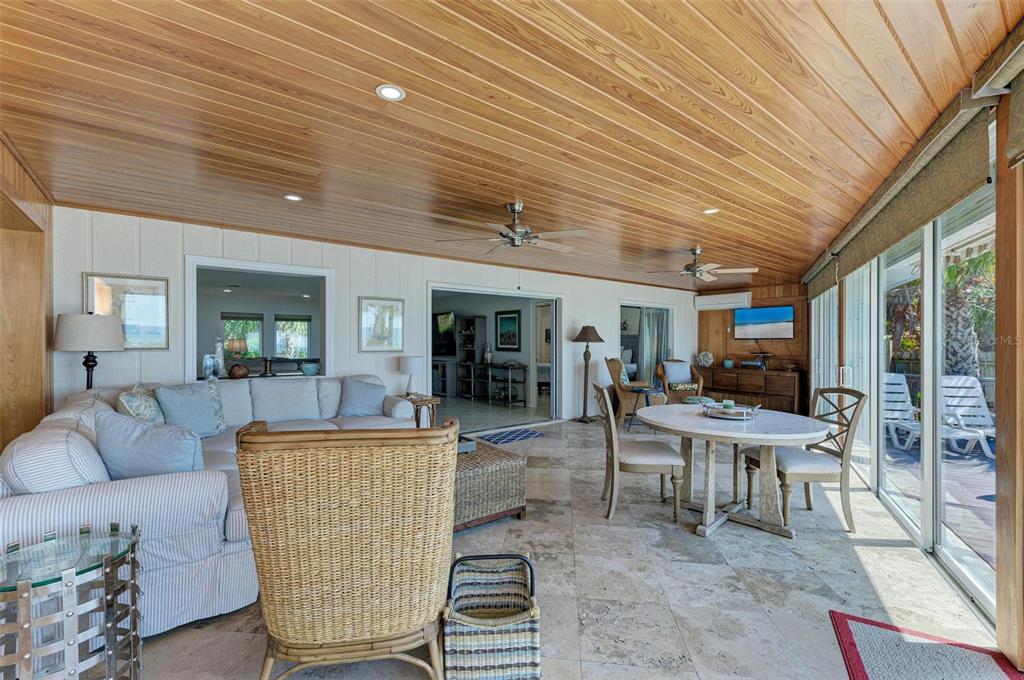 8320 Manasota Key Road Englewood, FL 34223 - Photo 36 of 58 a living room with furniture and a flat screen tv