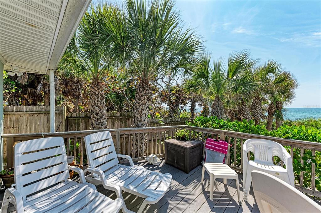 8320 Manasota Key Road Englewood, FL 34223 - Photo 45 of 58 a view of a patio with table and chairs potted plants with wooden floor and fence