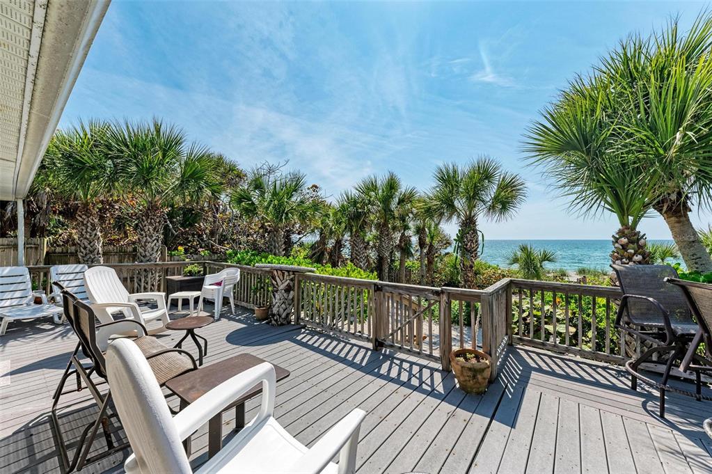 8320 Manasota Key Road Englewood, FL 34223 - Photo 46 of 58 a view of a balcony with wooden floor and outdoor seating