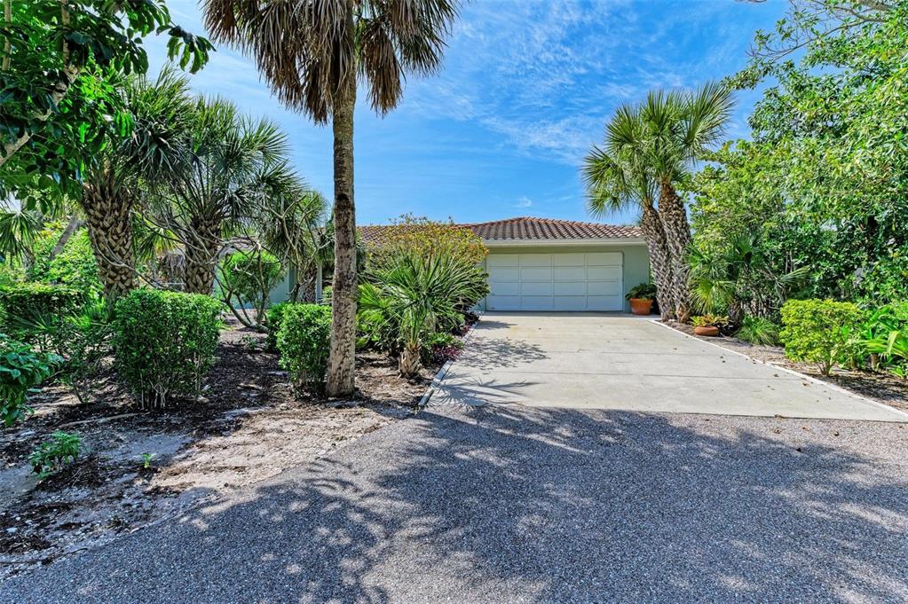 8320 Manasota Key Road Englewood, FL 34223 - Photo 6 of 58 a view of a yard with potted plants next to a road
