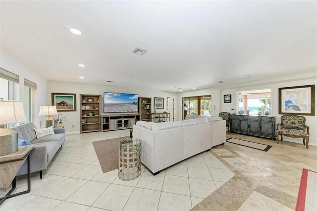 a living room with furniture a large window and gym equipment