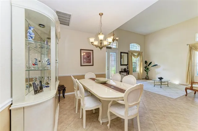a view of a dining room with furniture and a chandelier