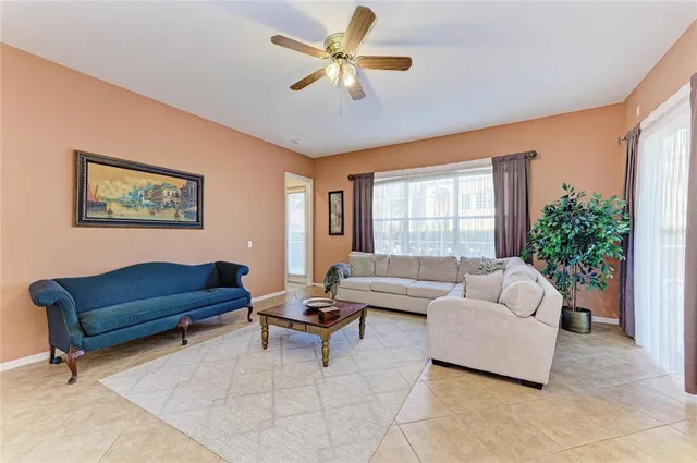 a kitchen with stainless steel appliances kitchen island granite countertop a refrigerator a oven and white cabinets with wooden floor