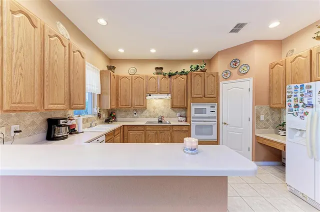 a kitchen with a sink a counter top space and cabinets