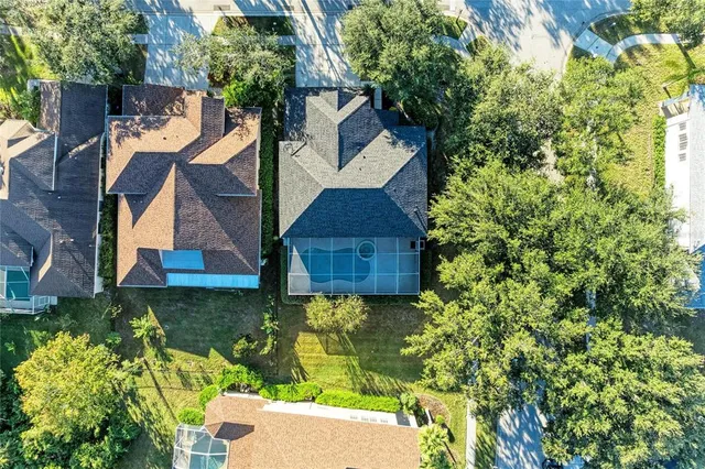 an aerial view of a house with a yard
