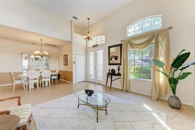 a dining room with furniture and chandelier