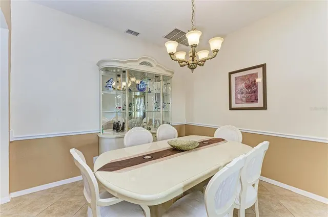 a view of a dining room with furniture and chandelier