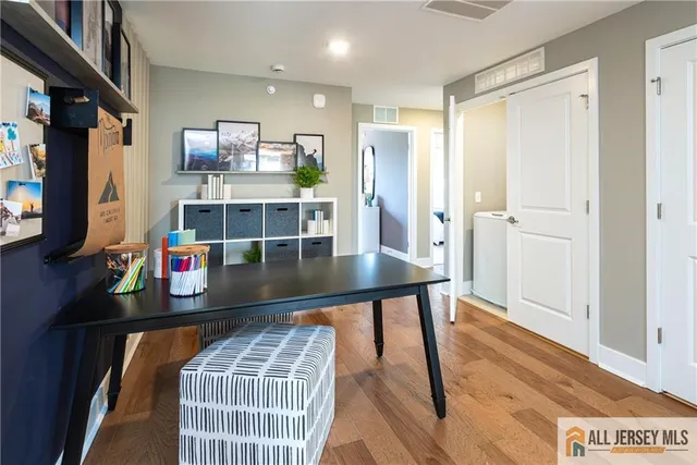 a room with stainless steel appliances furniture a rug and a window