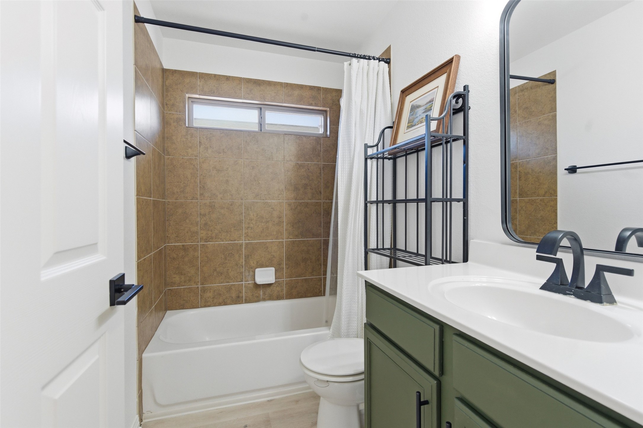 2513 Winchell Lane Austin, TX 78725 - Photo 11 of 23 a bathroom with a sink a toilet and shower